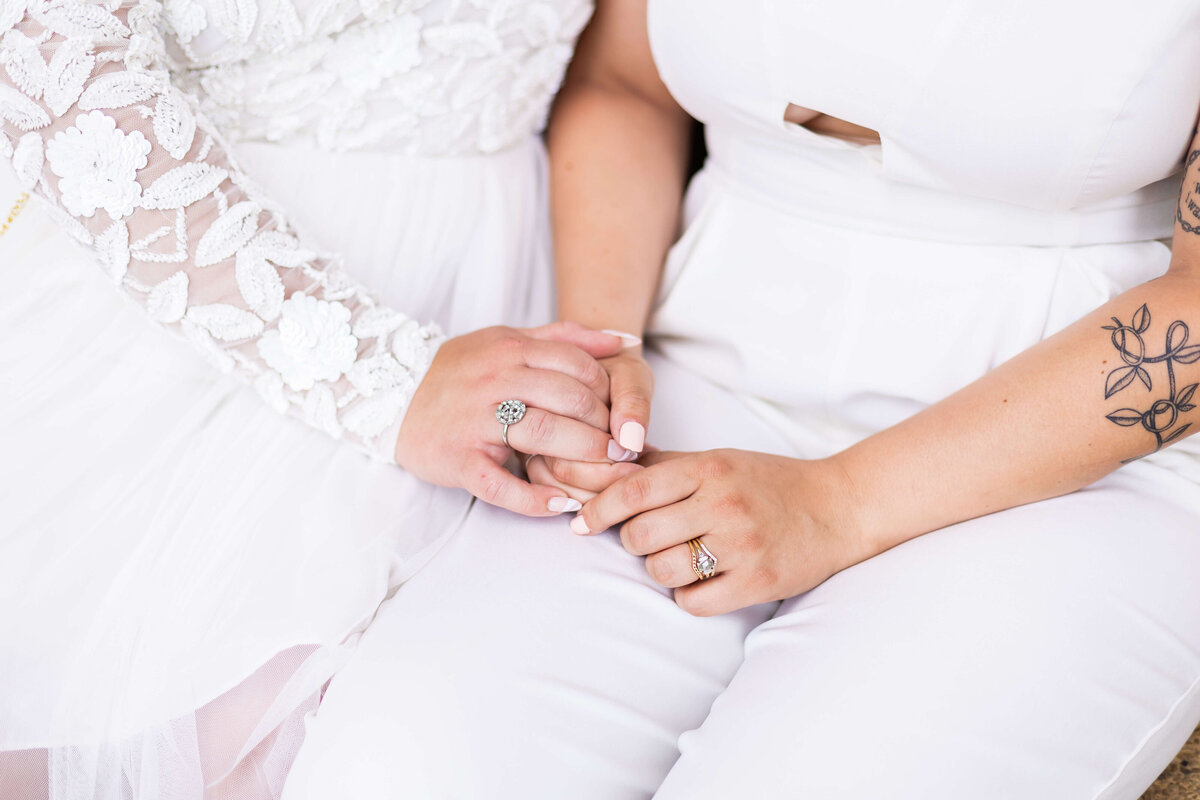Brides holding hands at LGTBQ wedding in Centennial Park, Nashville,TN
