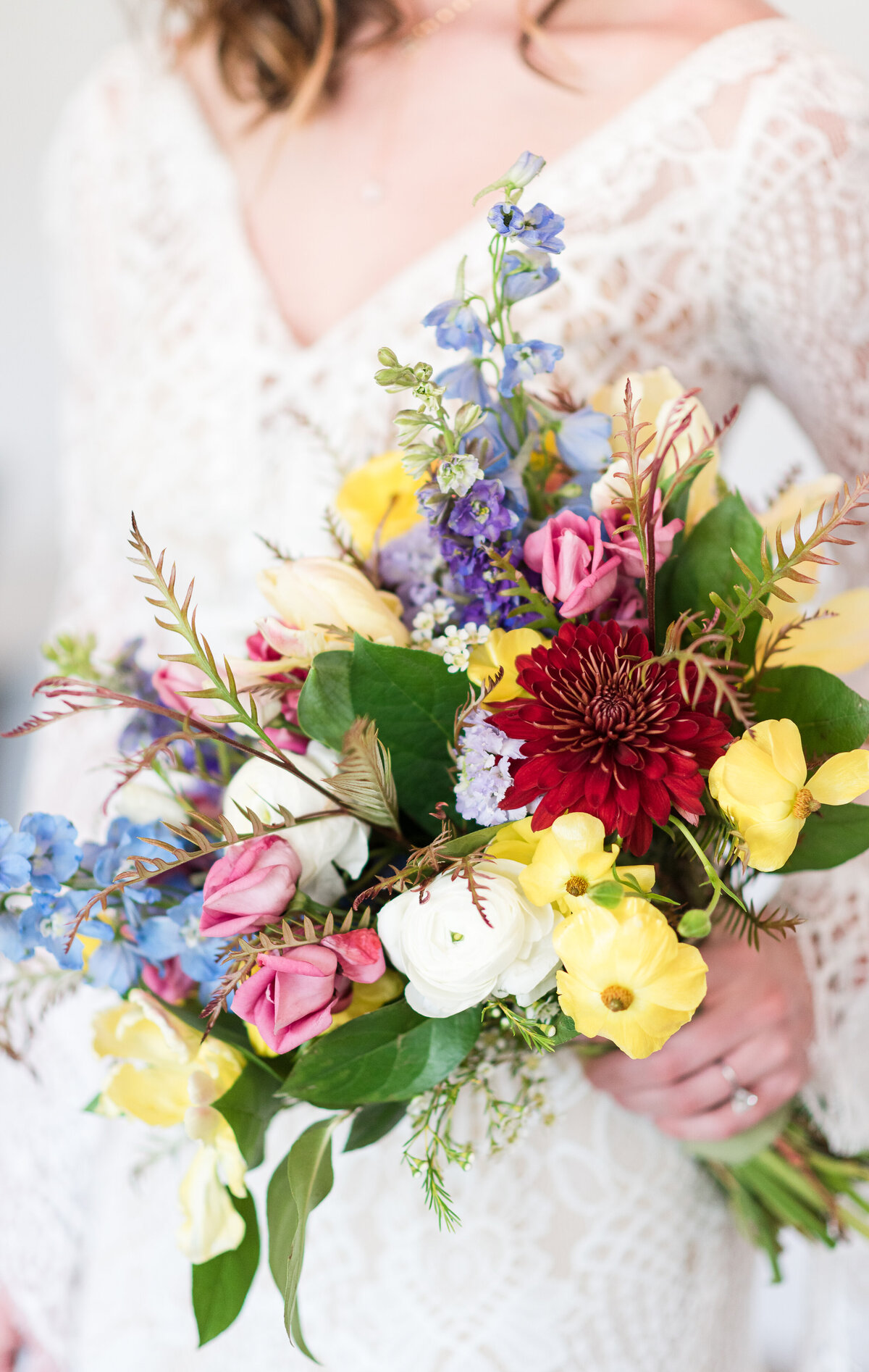 denver wedding photographer captures detail shot of bright floral bridal bouquet for a colorado wedding