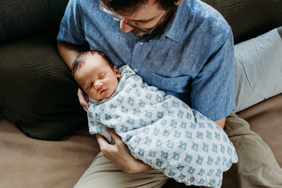 dad holding newborn daughter