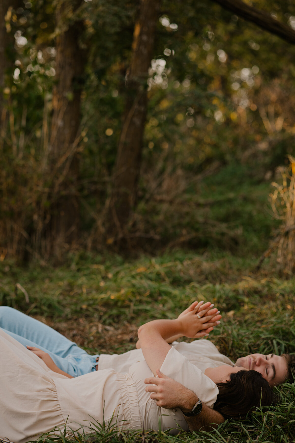 Couple's engagement session in Omaha during golden hour, surrounded by warm fall foliage – captured by Tori Nichole Photography. Authentic, romantic moments in a stunning autumnal setting, reflecting the beauty of the season and their love story.