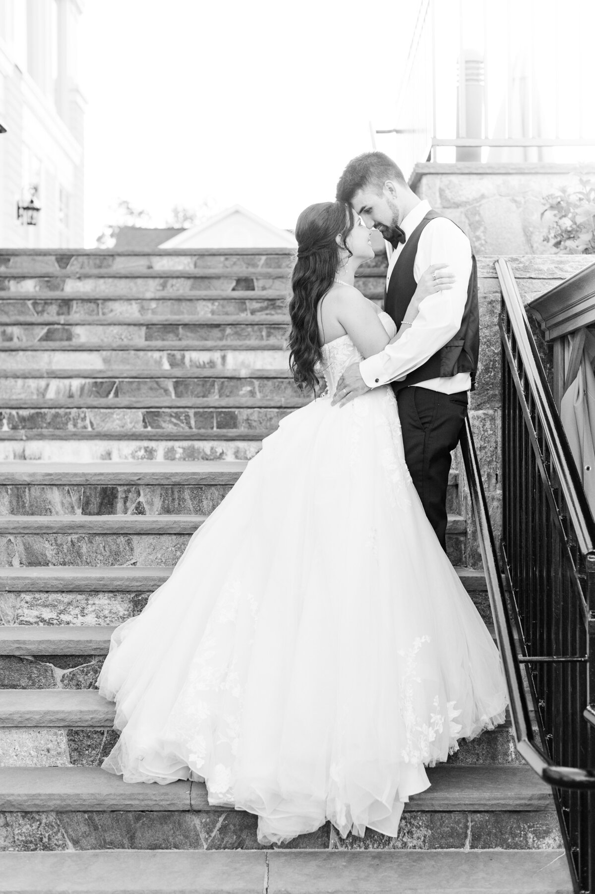 couple nuzzling on staircase