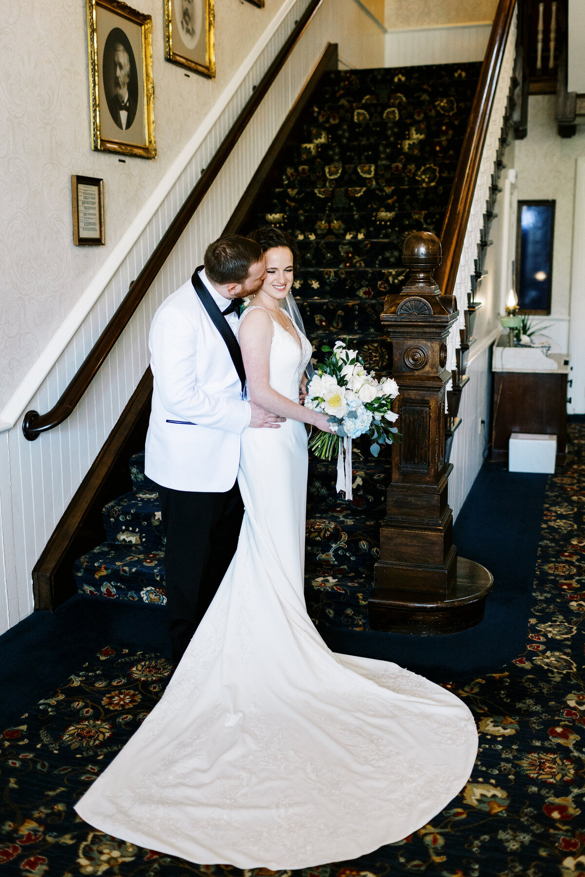 Groom kissing his bride at St. James Hotel