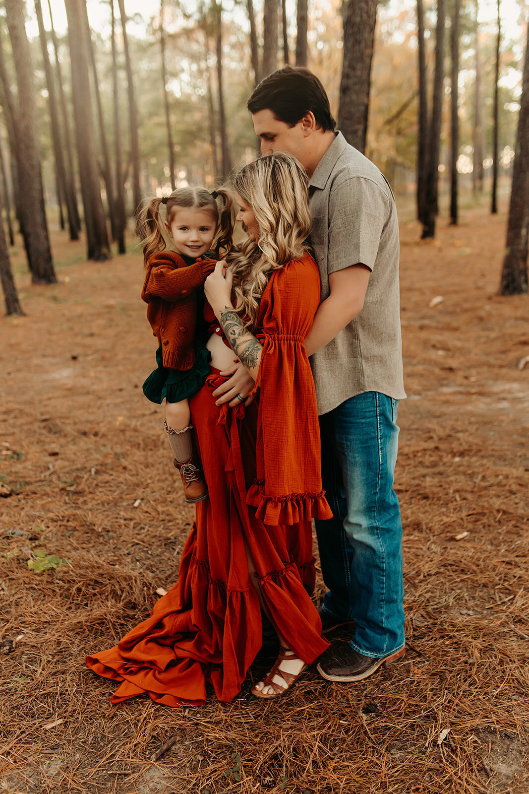 Family maternity photography session in Liberty TX with parents and toddler in woods, warm tones
