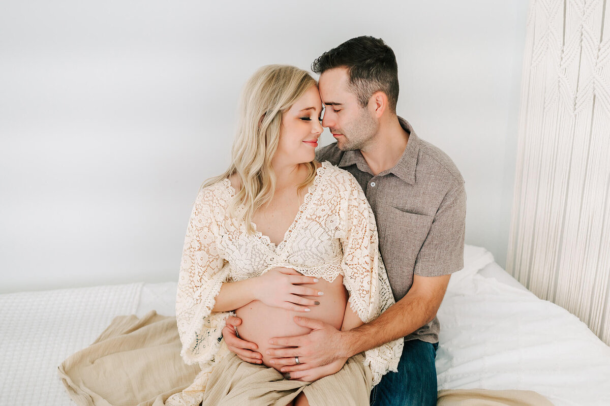 maternity photo in Springfield MO of couple putting forehead together holding baby bump