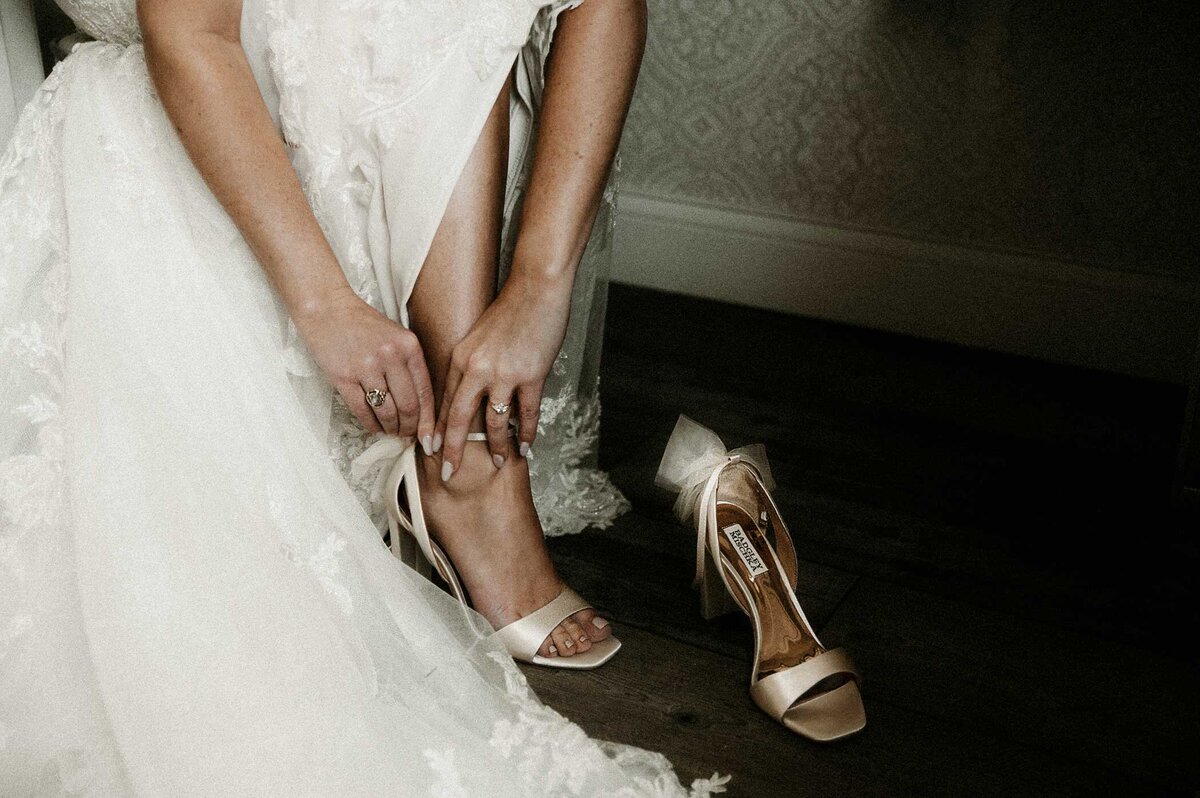 bride-putting-on-shoes-9th-street-abbey
