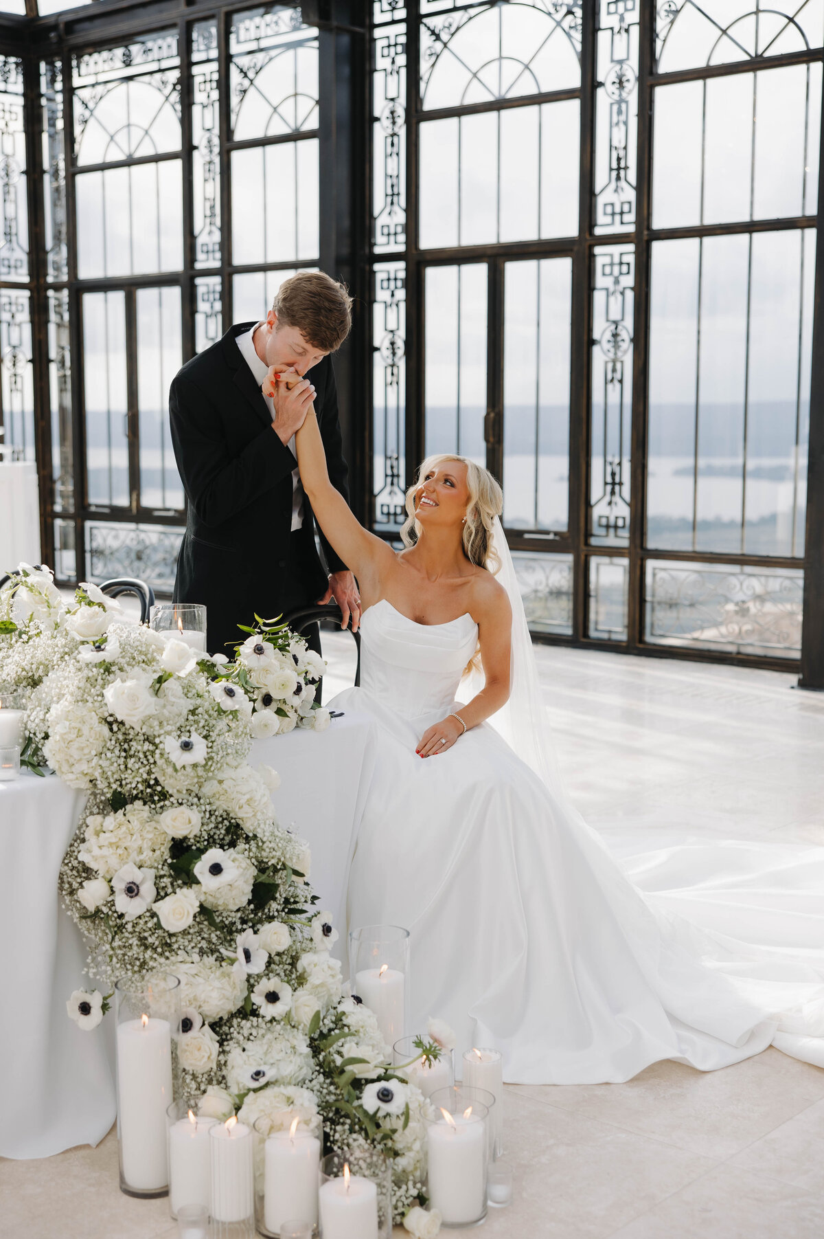Groom Kissing Bride's hand in a reception Stone Haven Wedding Venue