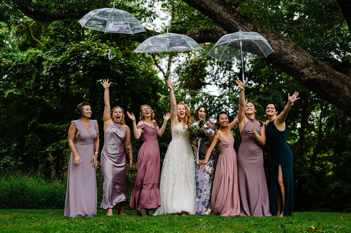 brides toss umbrellas in the air during photos at a litchfield ct wedding