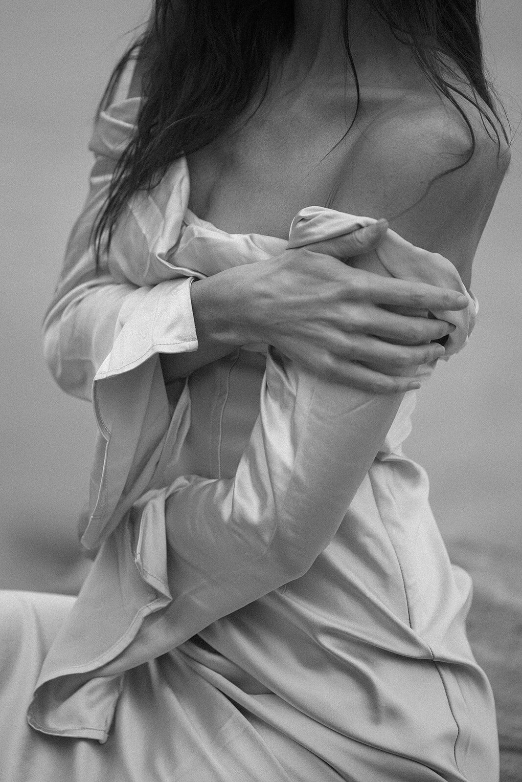 Close up of Bride holding herself in wedding gown