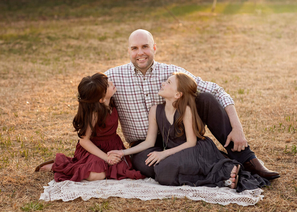 NJ portrait photos of dad with his two daughters on a blanket