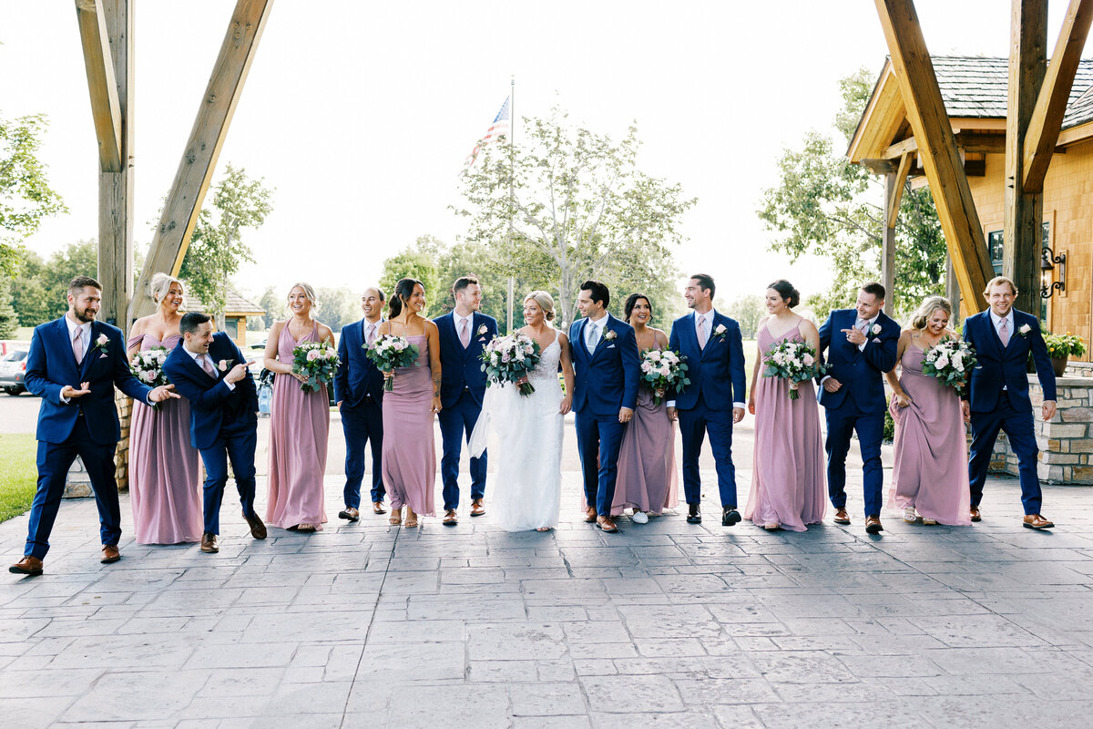 wedding party walking together in excitement at Minnesota wedding