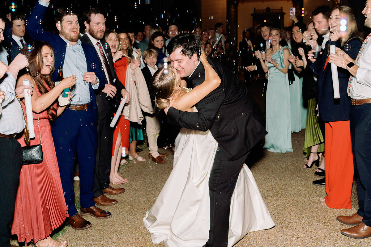 Callie and Hayes share a romantic kiss during their bubble exit at Burritt on the Mountain, surrounded by cheering guests.