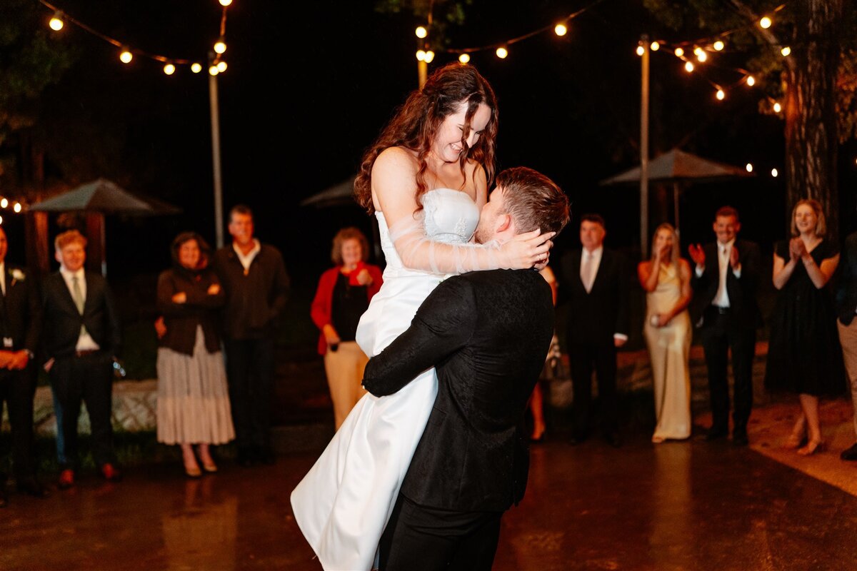 A heartwarming moment captured: a couple swaying together on the dance floor at their wedding reception, enveloped in love and joy.