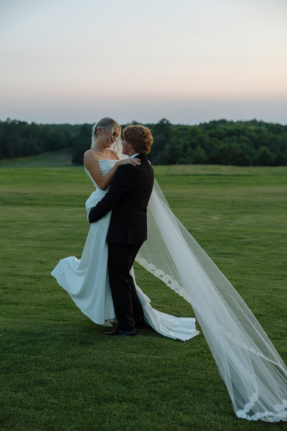 Groom lifts the bride and spins her
