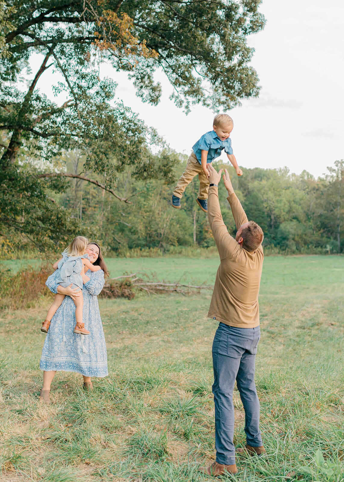 Dad throwing son up in the sky