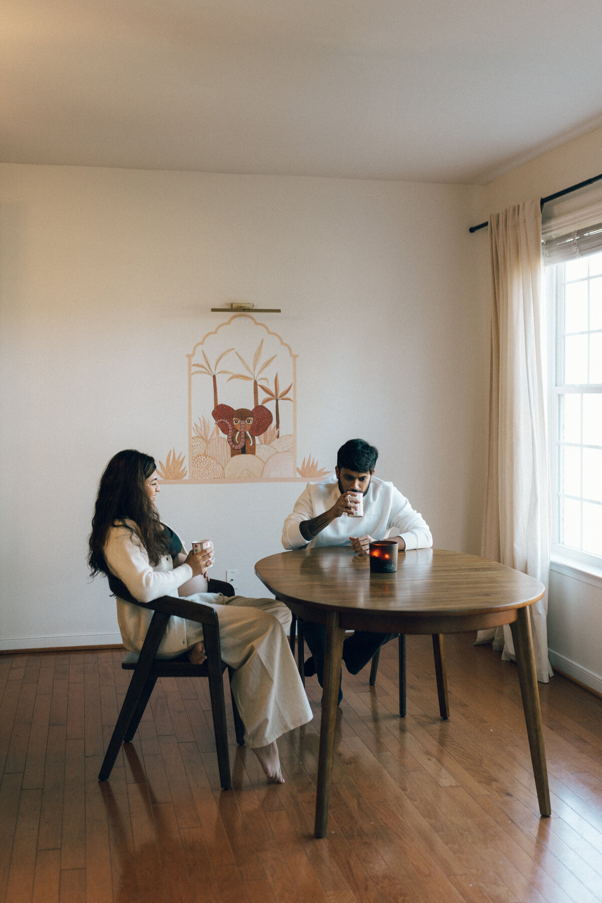 pregnant couple sit in kitchen