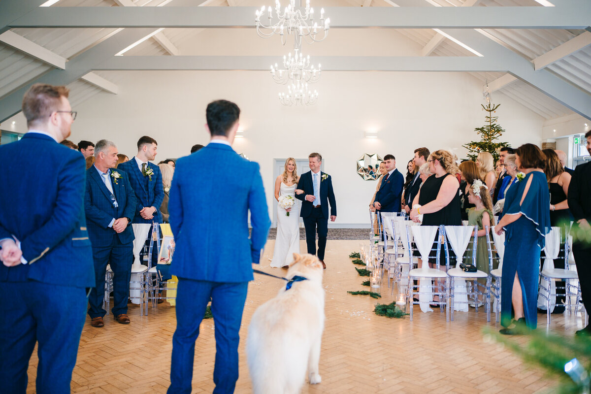 Groom watching his bride be walked down the aisle  at Mytton Fold Hotel taken by wedding documentary photographer and videographer Anthony Horseman