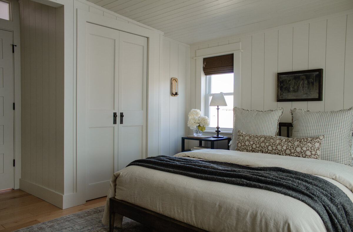 Primary bedroom renovation by Nadine Stay. Vertical  wood plank walls and wood plank ceiling. Low bedroom ceiling before and after.