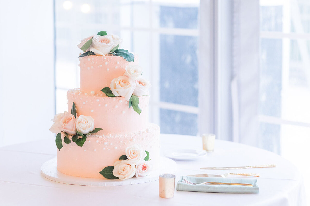 Pink colored wedding cake design with pink flowers