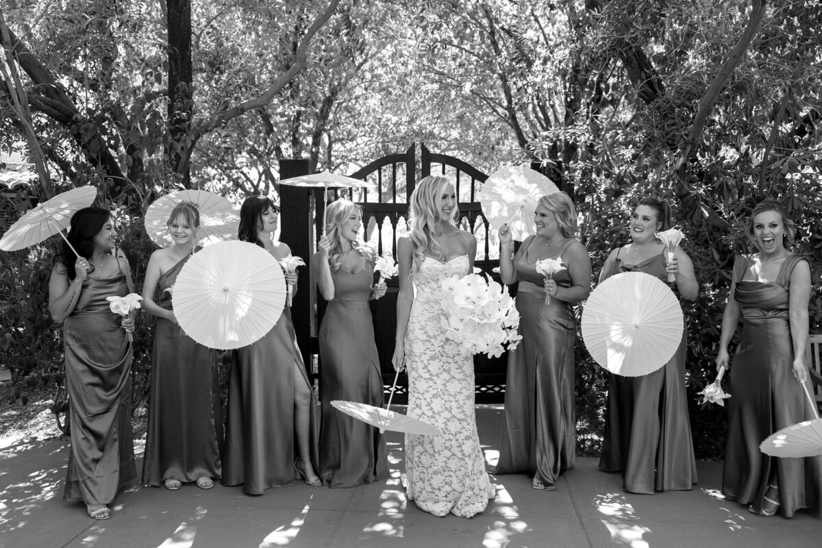Bride and bridesmaids holding parasols at El Chorro in Paradise Valley, Arizona