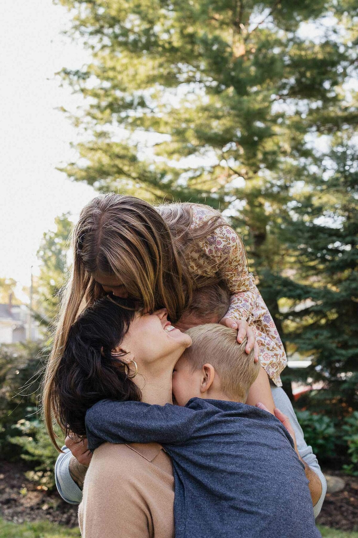 Big family hug during Cleveland Heights family photography session at home.