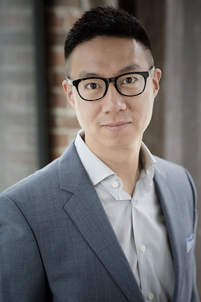 A man in a suit with a slight smile