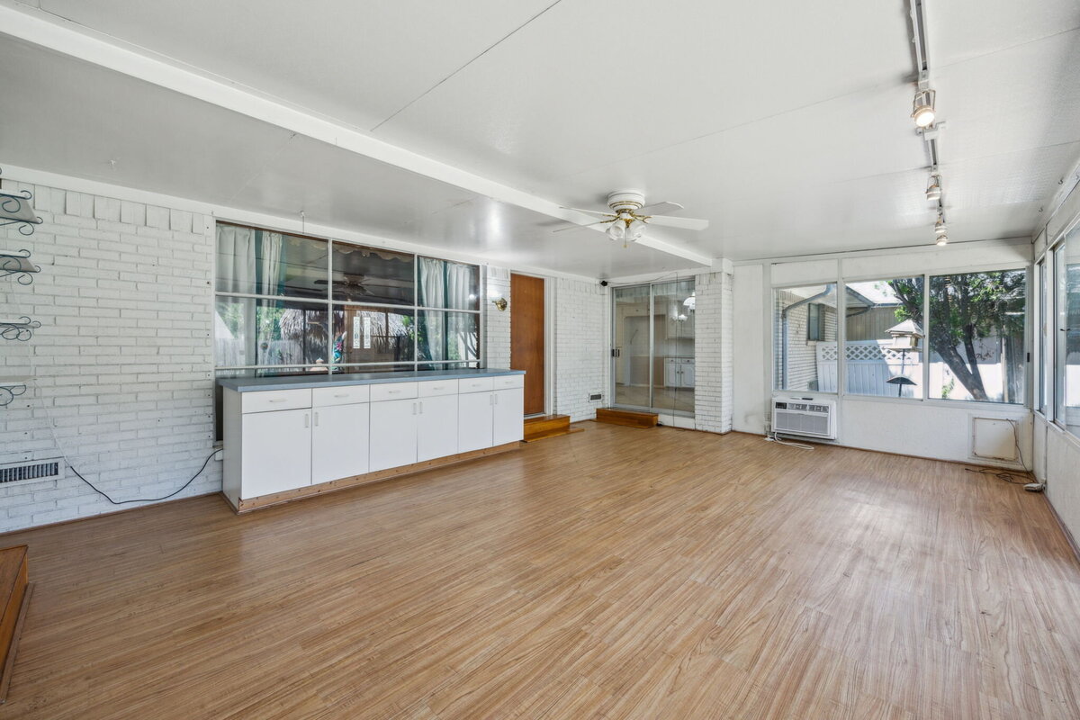 sunroom_with_built-in_storage_white_brick_and_garden_views_-_edgecrest_dallas_tx