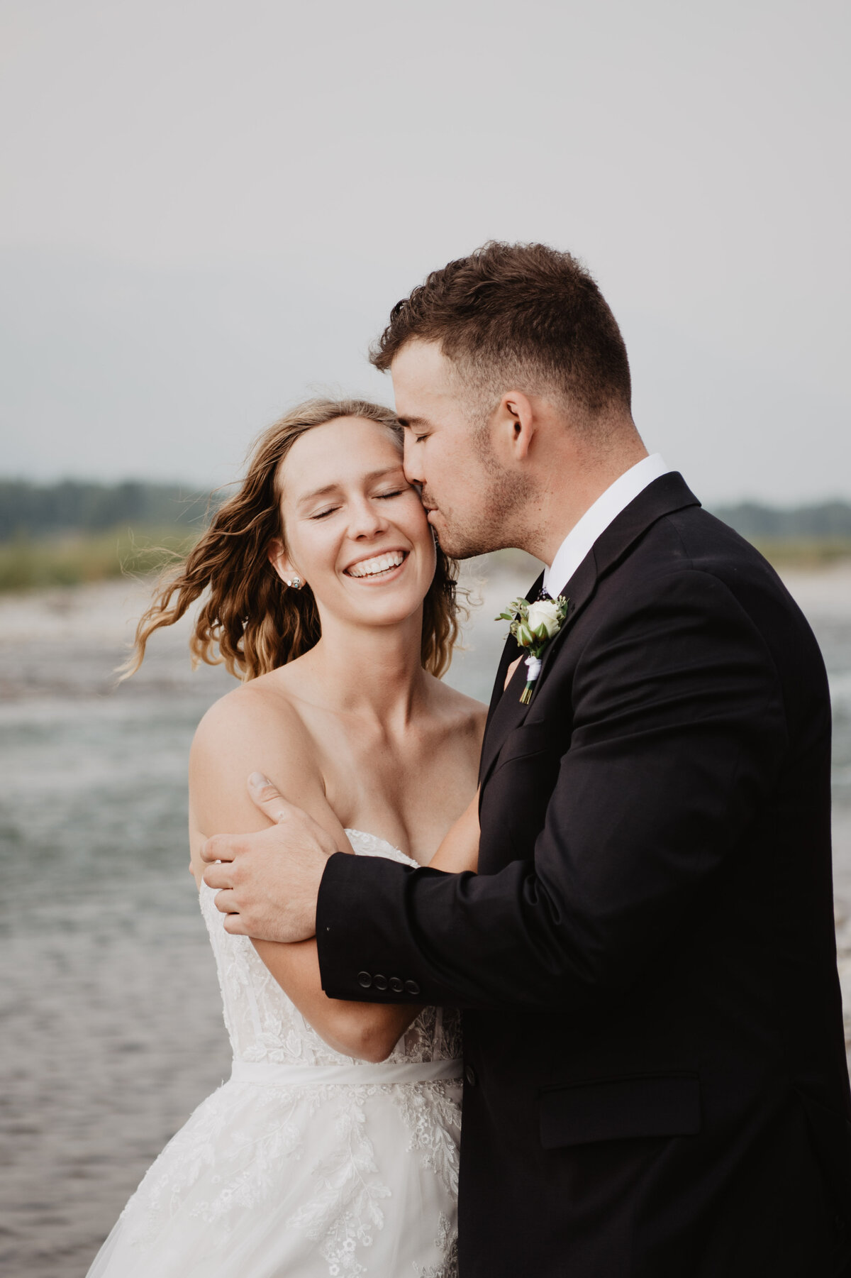 Jackson Hole Photographers capture groom kissing bride's cheek