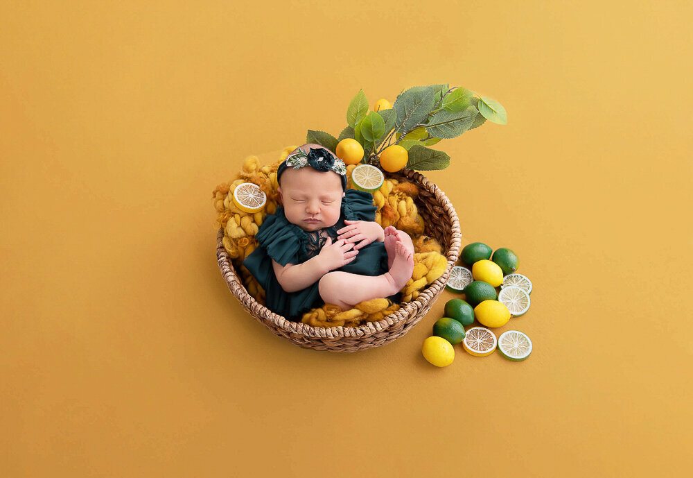 baby girl in a green outfit with lemon and limes.
