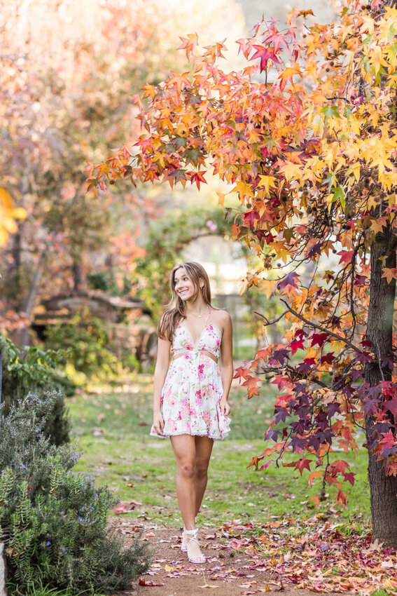teen girl walking under fall leaves