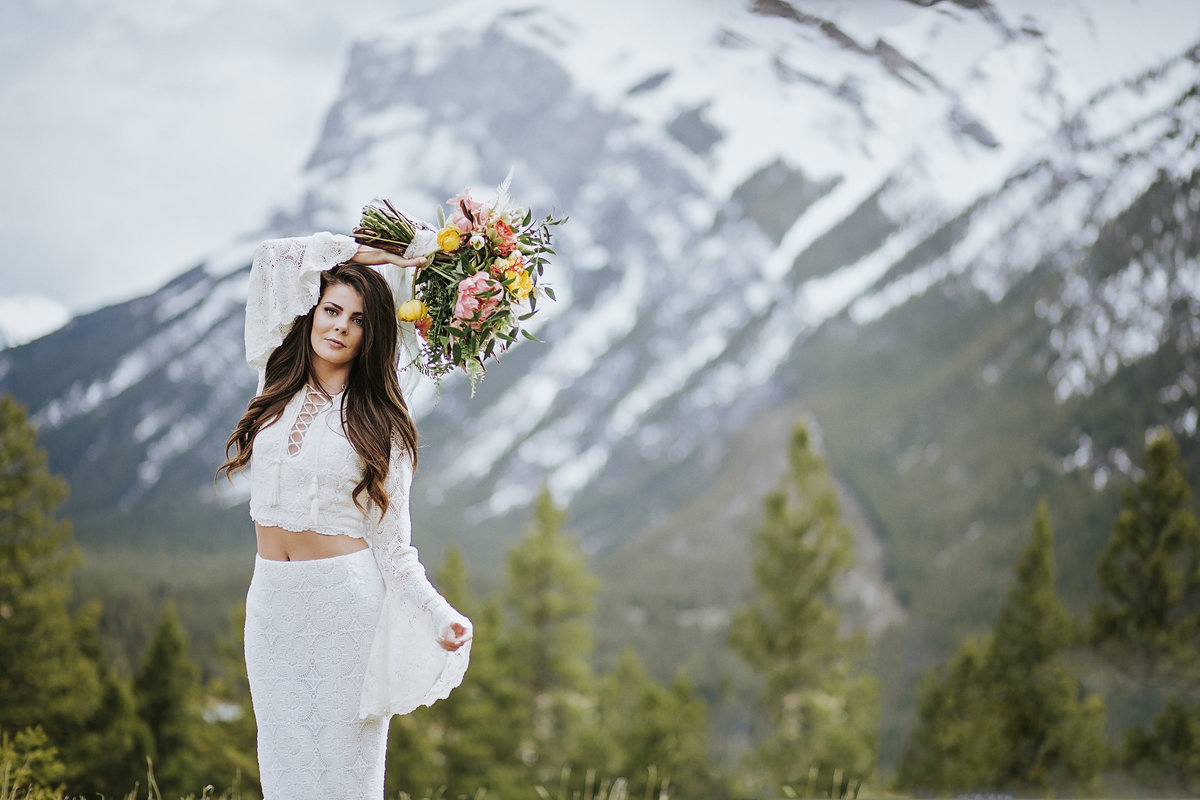 Stunning bride in Delica Bridal gown on top of Mountain in Banff