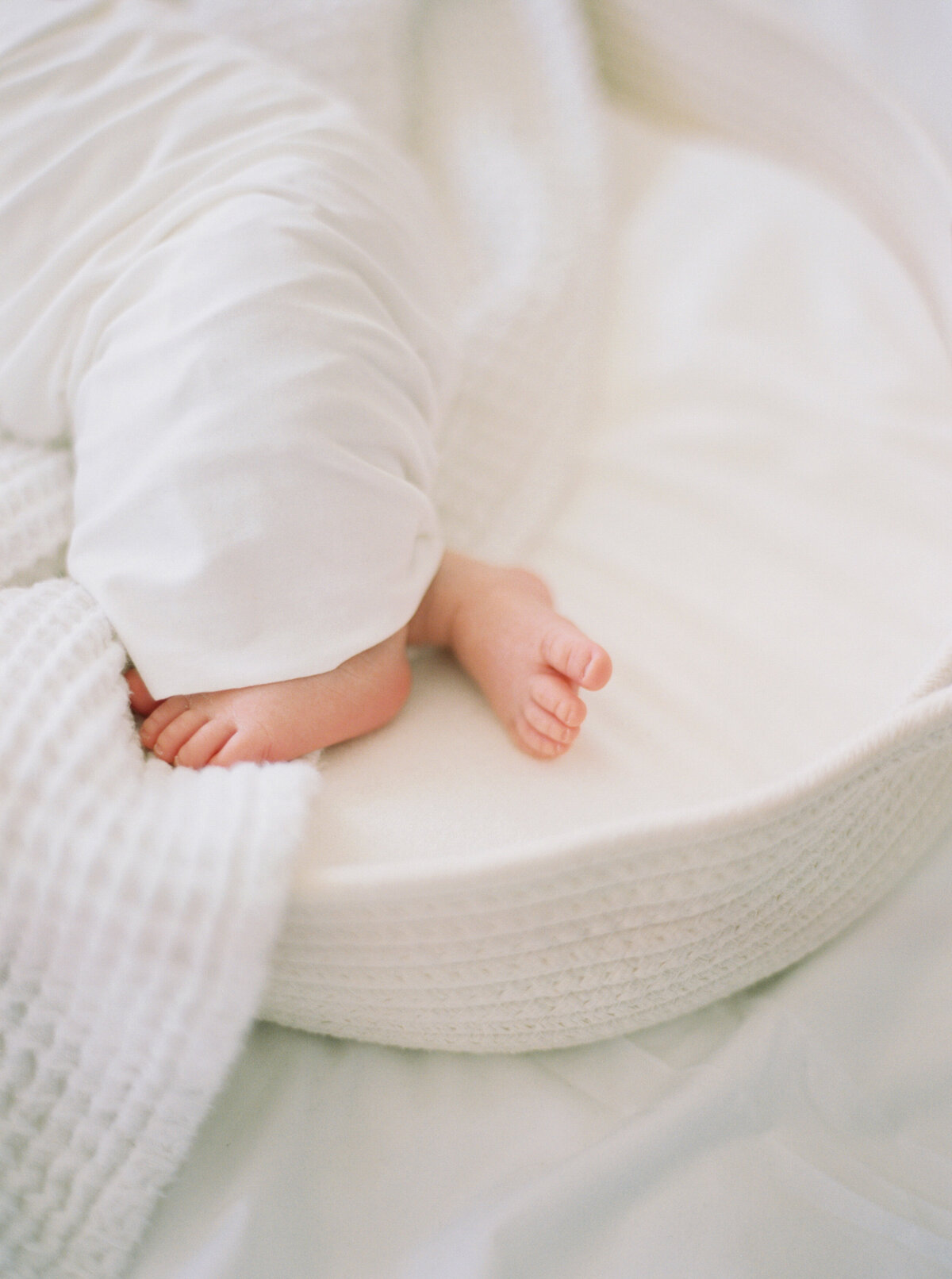 newborn baby boy toes  in all white taken by photographer milwaukee wi talia laird photography
