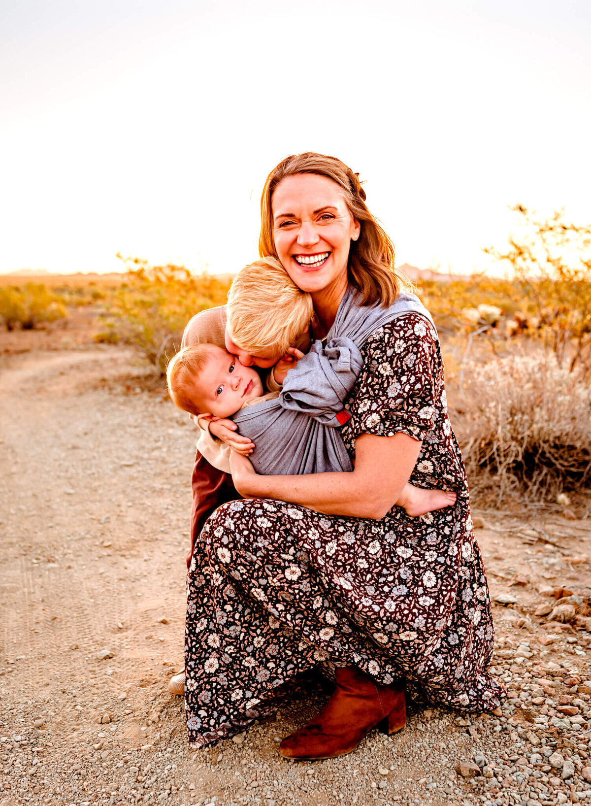 mom posing for photograph while sons snuggle in Arizona