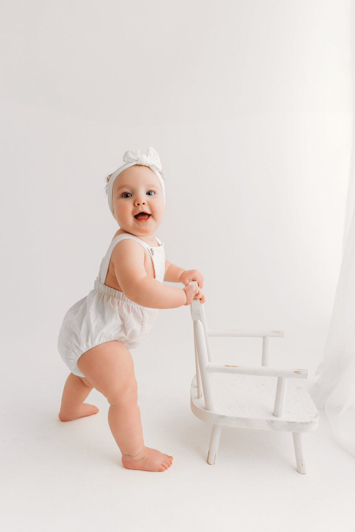 infant portrait session on white backdrop