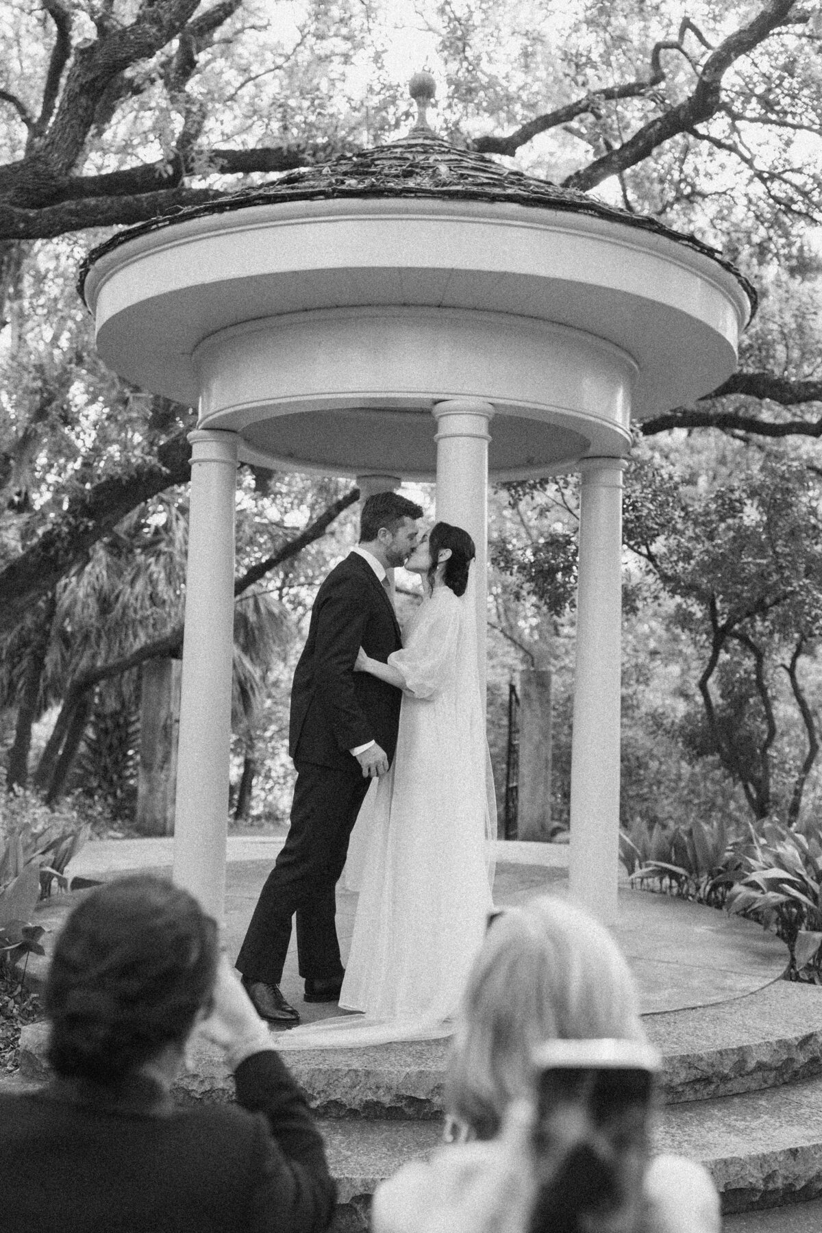 Bride and groom kissing after wedding ceremony  at Laguna Gloria in Austin