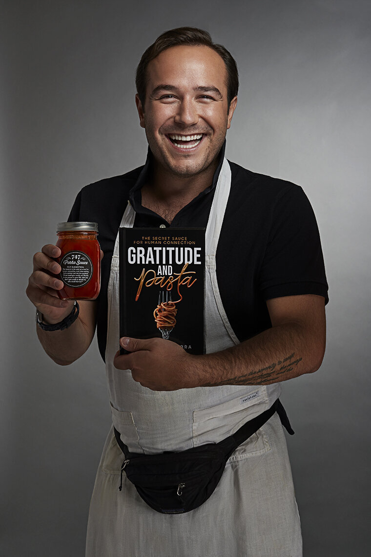 Energetic portrait of Chris Schembra, holding a small item and radiating approachability, captured by Ylva Erevall.