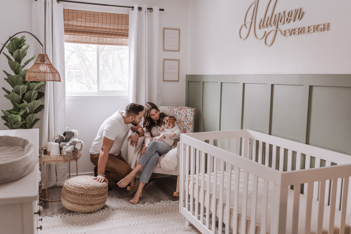 parents with baby in nursery