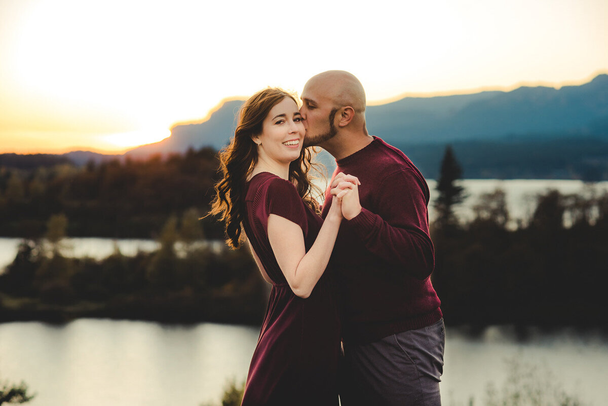 man kissing woman