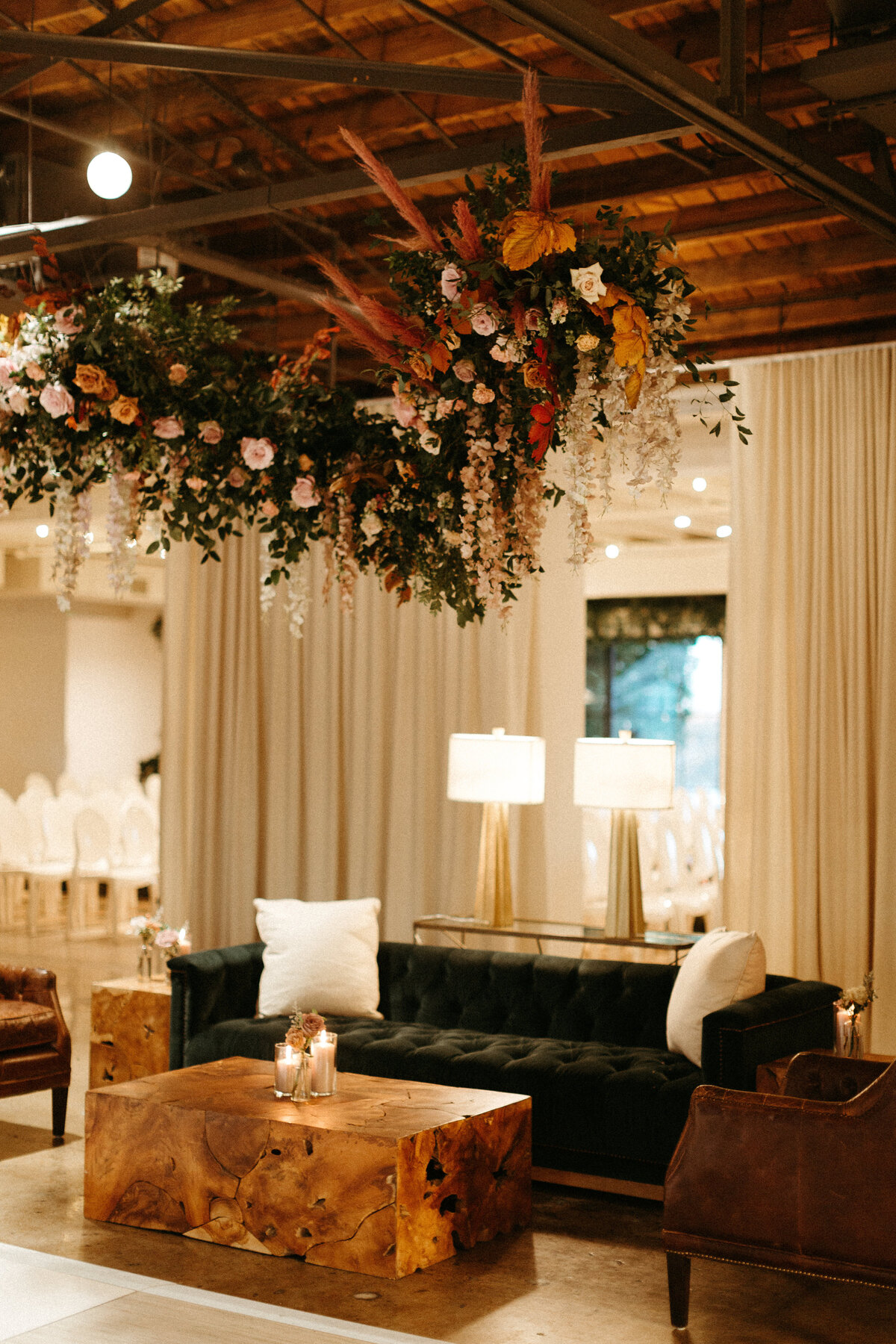 Stunning floral installations bring warmth to this Great Gatsby inspired wedding with florals of terra cotta, dusty pink, and burgundy hues. Petal heavy roses, copper beech, and pink pampas grass accents. Designed by Rosemary and Finch in Nashville,
