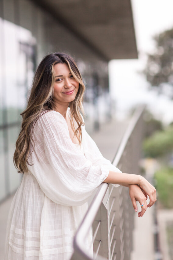 Point Loma Nazarene senior leaning against railing