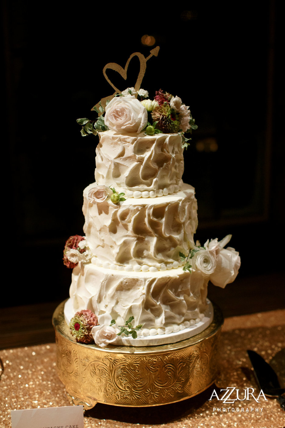 3 tiered wedding cake with fresh flowers