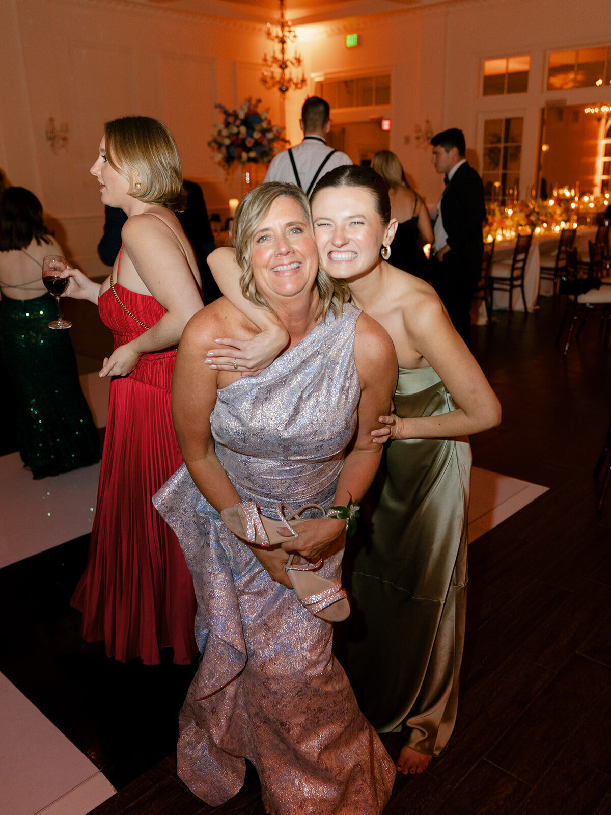mother of bride and bridesmaid dancing at reception