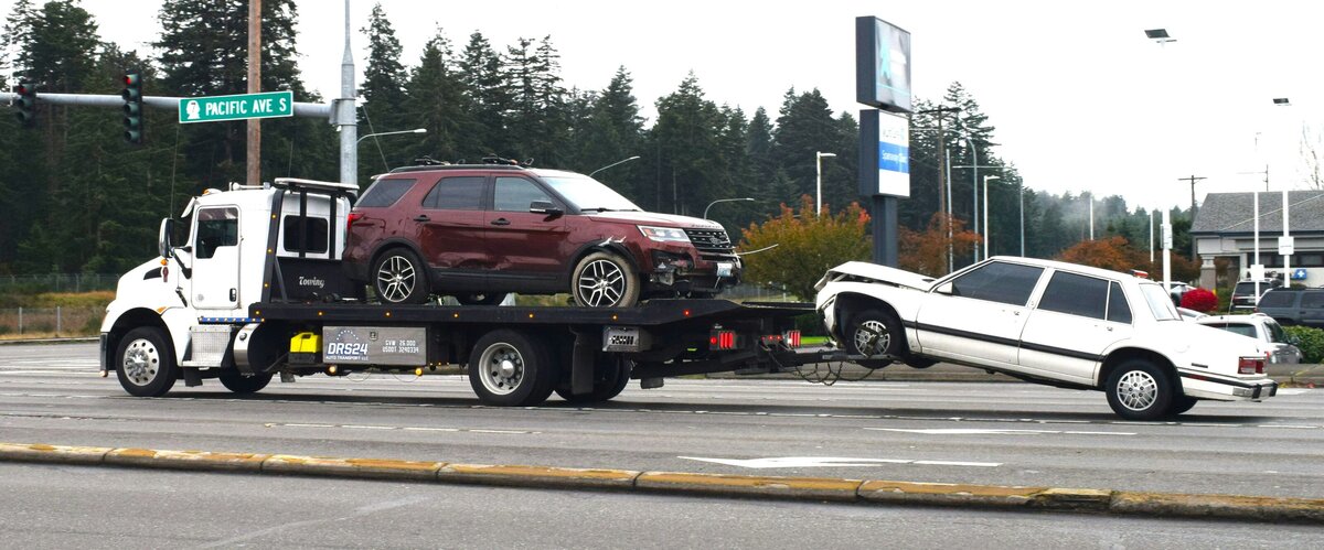 Cars being towed away by tow truck