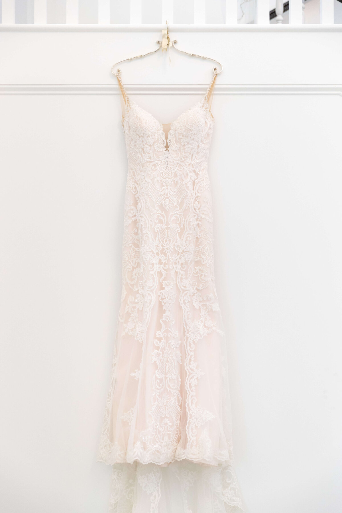 Lace wedding gown hanging up
