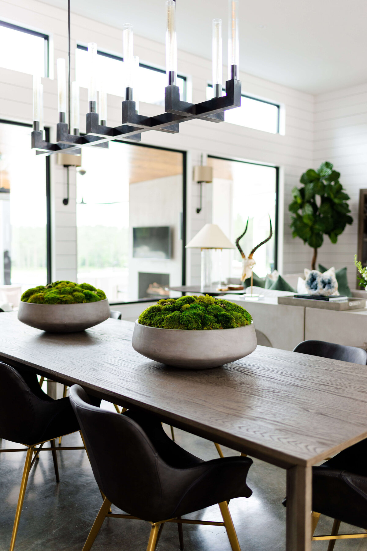 oyster creek studios building belt new build  black chairs around dining room table with succulents