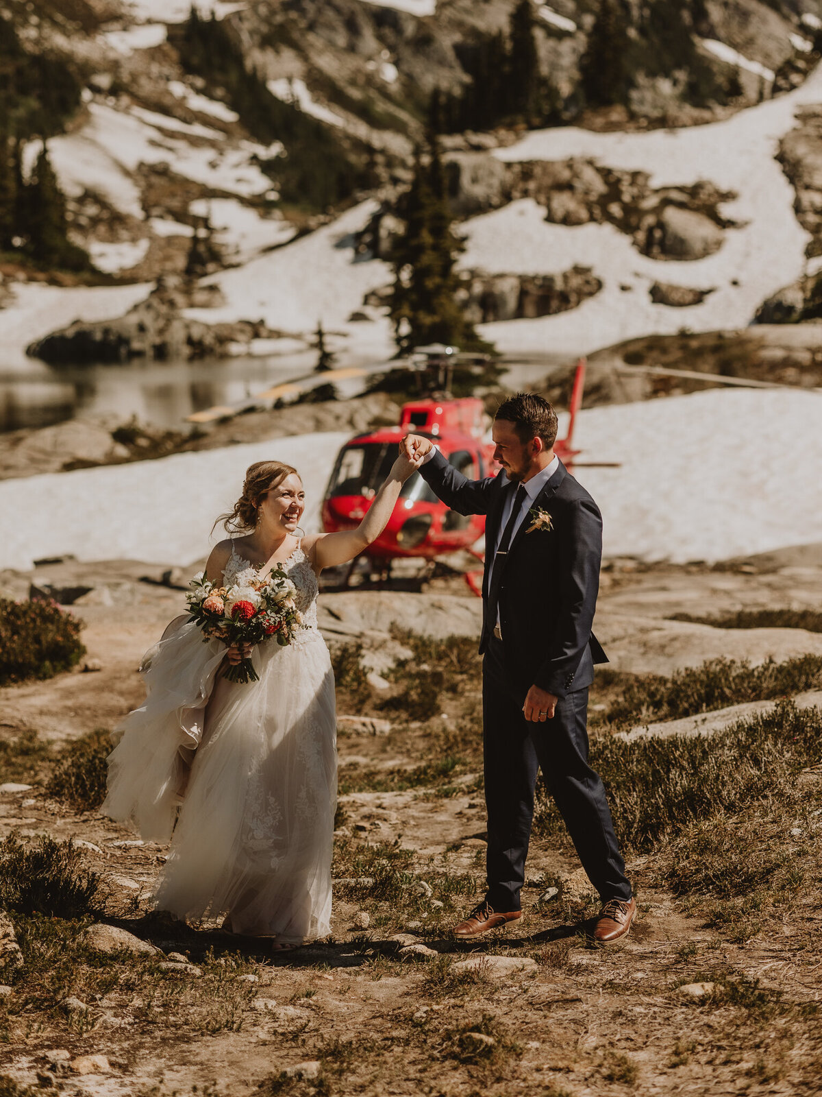 Bride and Groom dancing in front of helicopter
