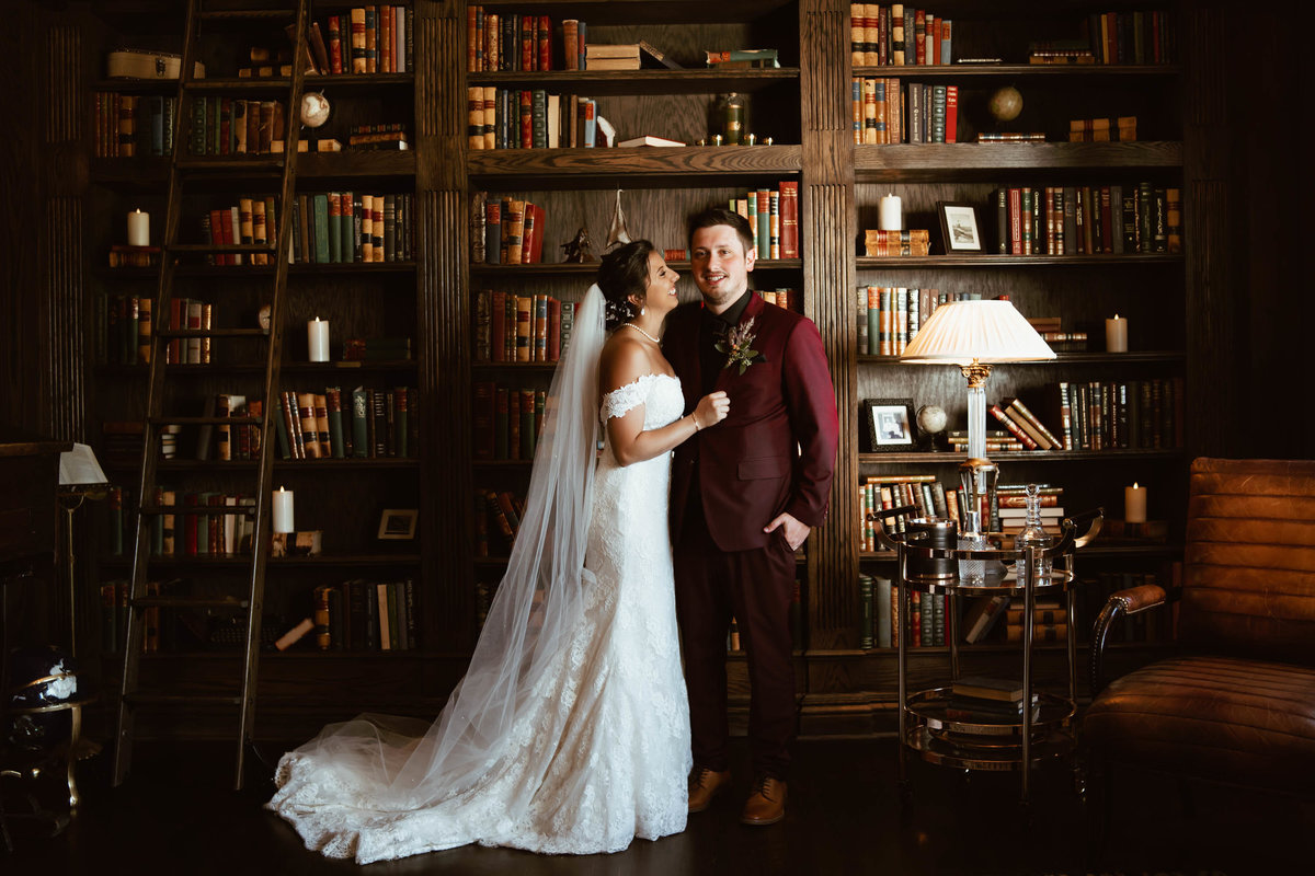 newlyweds pose in manor house library