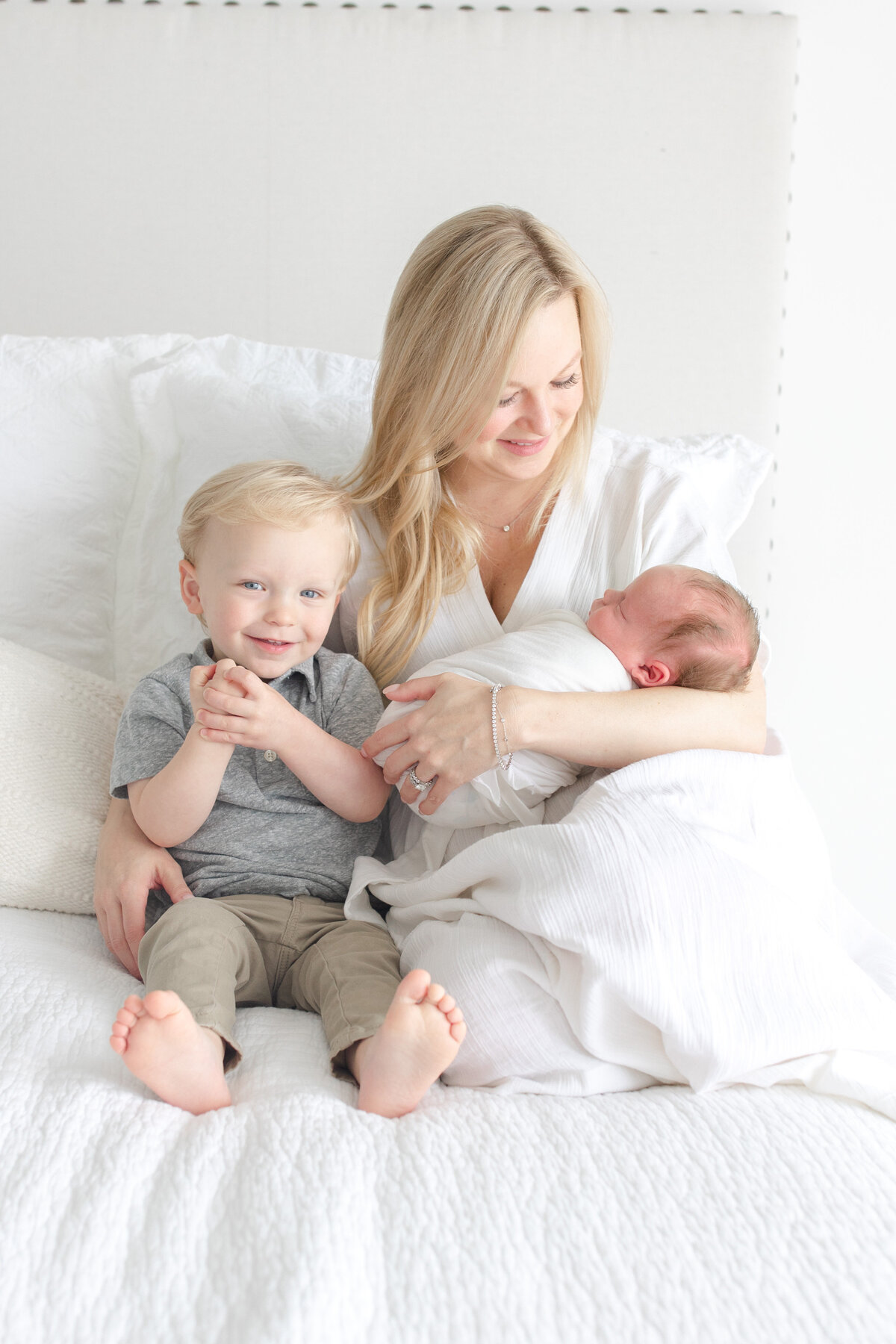 Atlanta baby photographer - mom holding baby and toddler in studio photoshoot in atlanta