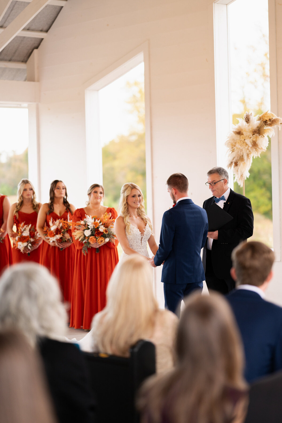 The bride and groom holding hands as they declare their commitment to one another during their wedding ceremony at Stokes Family Farm in Greenville, NC.