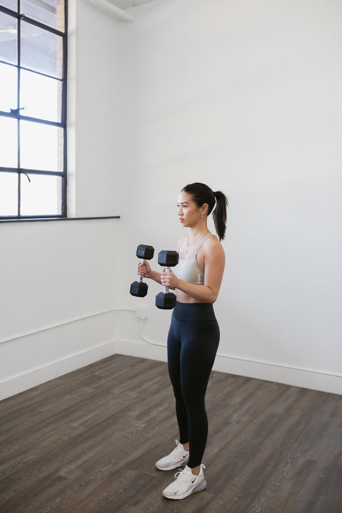 personal trainer curling dumbells
