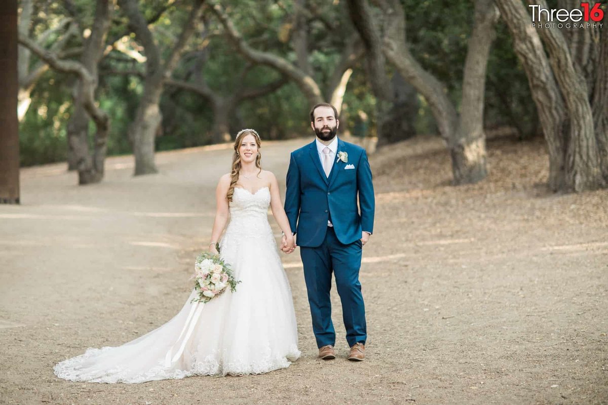 Bride and Groom pose for the wedding photographer